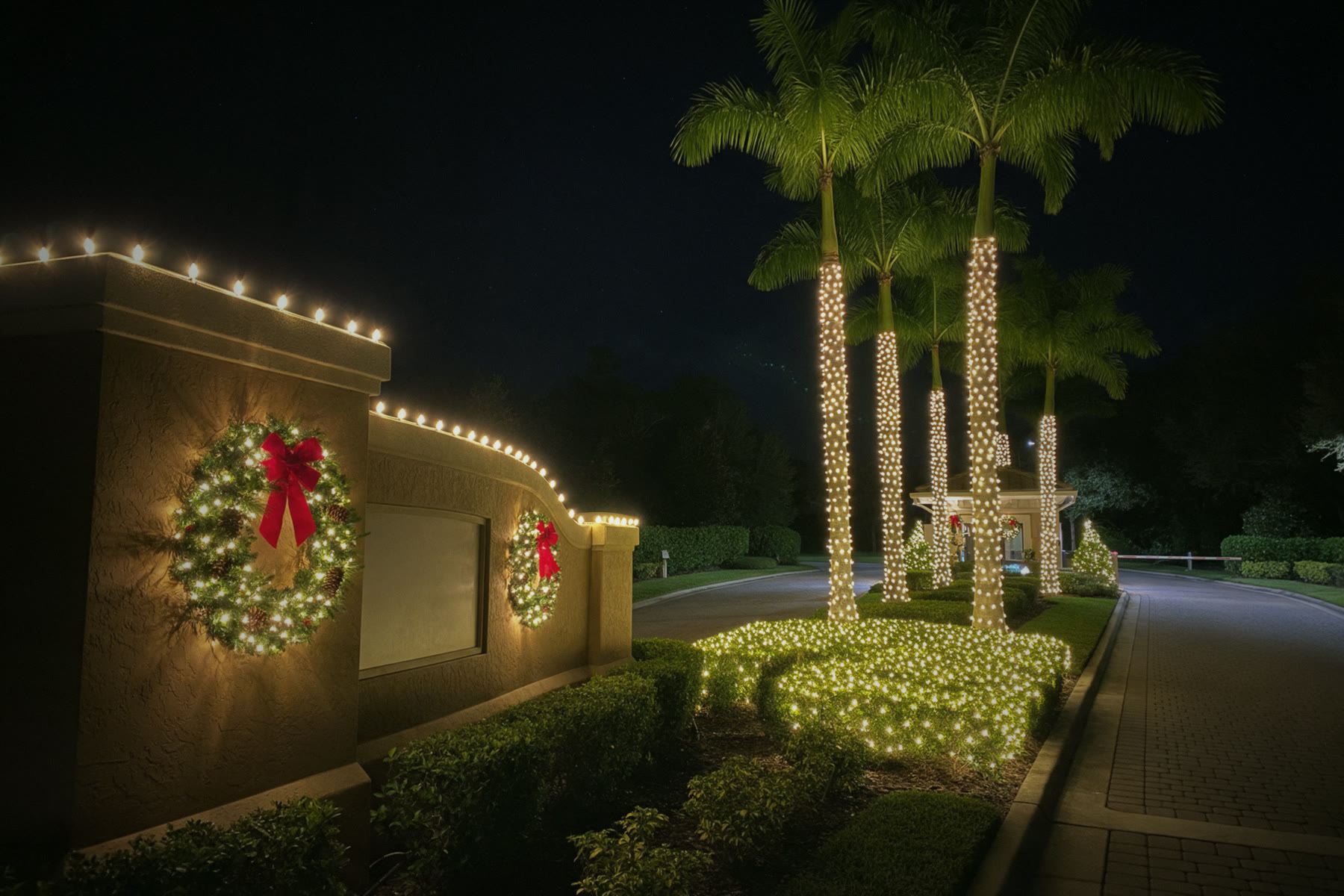 HOA entrance: Royal palms, monument, wreaths, hedge nets - Christmas lighting design reference